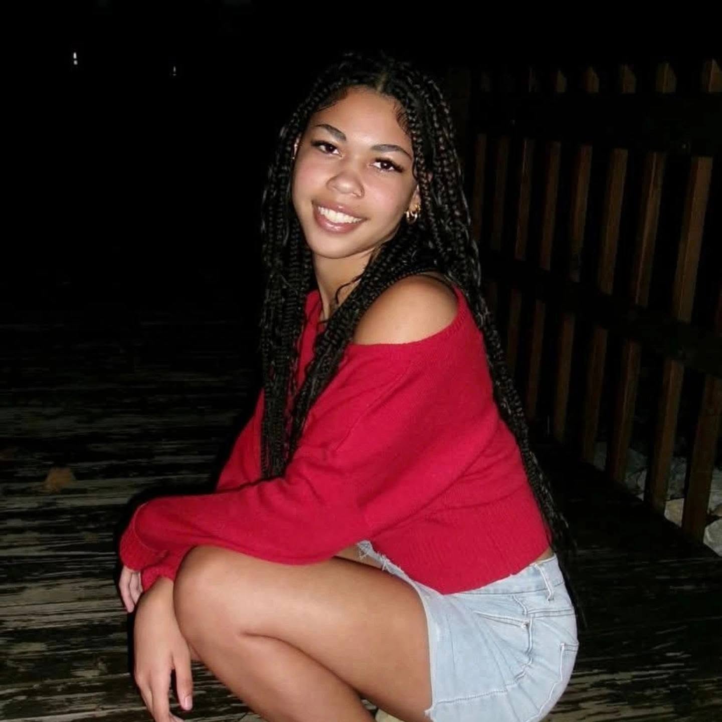 A family portrait of Kayla wearing red