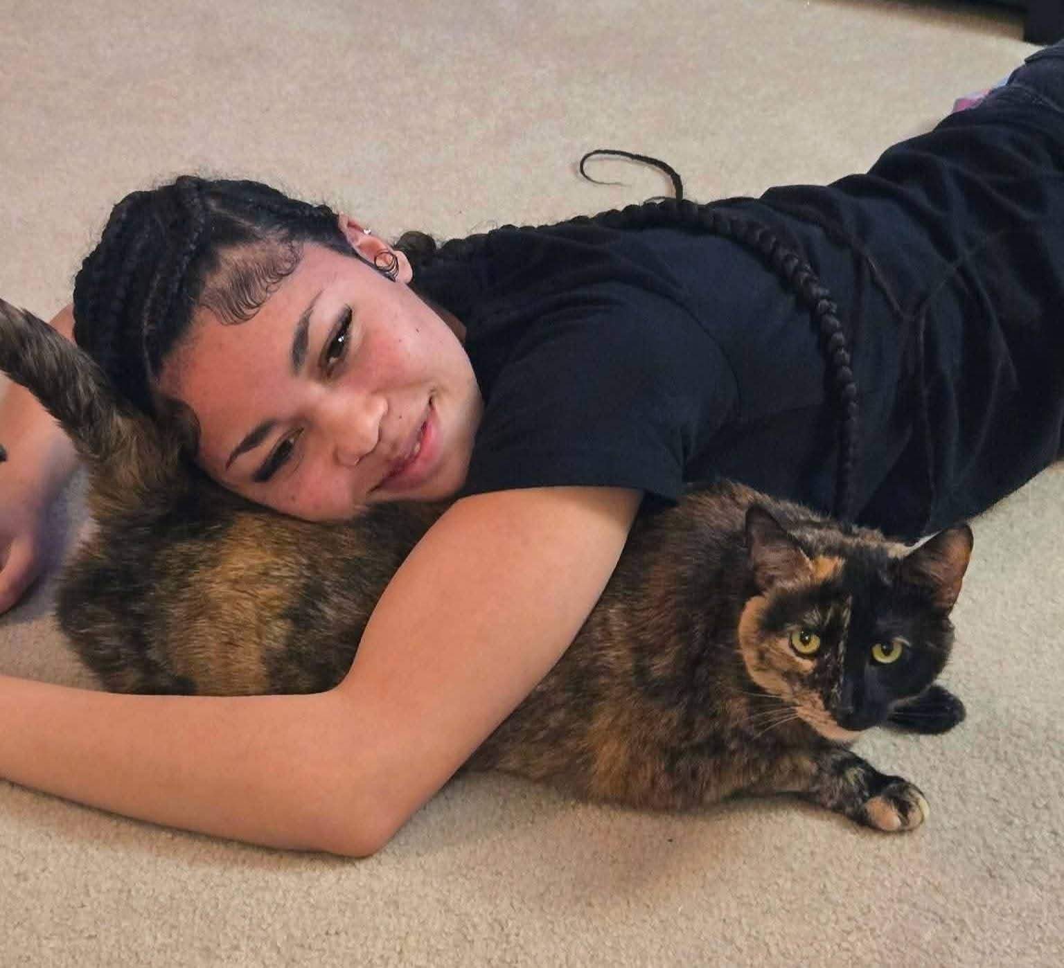 Kayla hugging a cat
