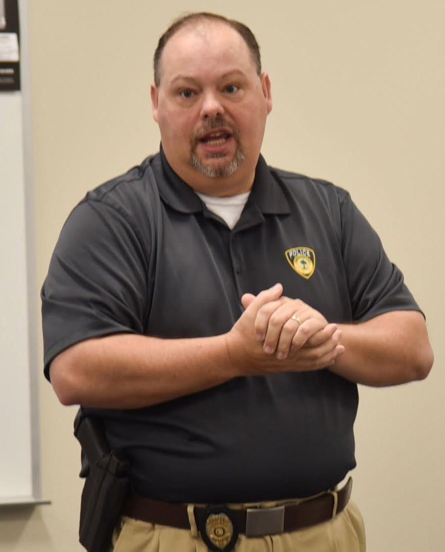 Police Chief T.J. Chaudoin, pictured with his hands clasped